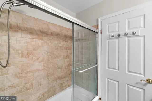 a bathroom with a glass shower door