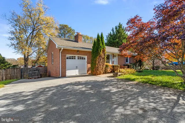 a view of a house with a yard and tree s