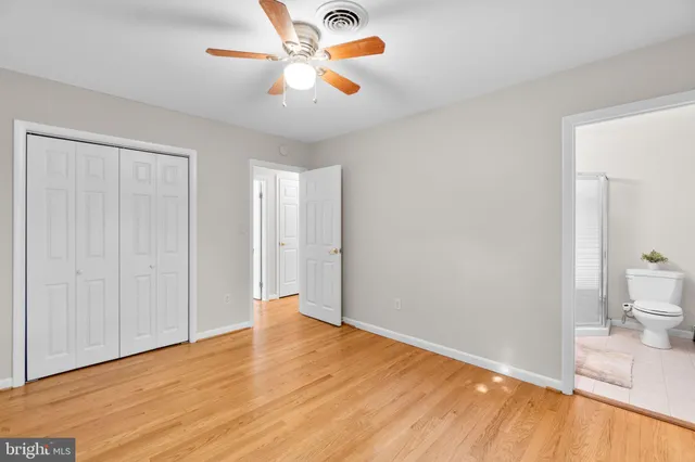 a view of a room with wooden floor and fan