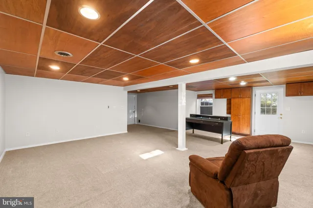 a living room with furniture and a ceiling fan