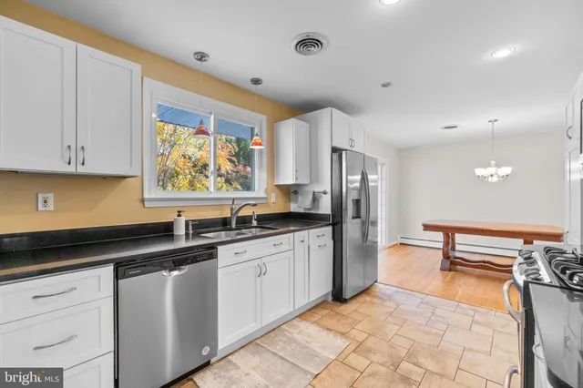 a kitchen with stainless steel appliances granite countertop a sink and cabinets