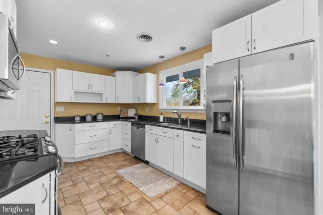 a kitchen with a refrigerator and a stove