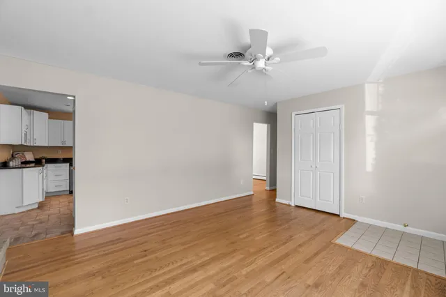 a view of an empty room with wooden floor
