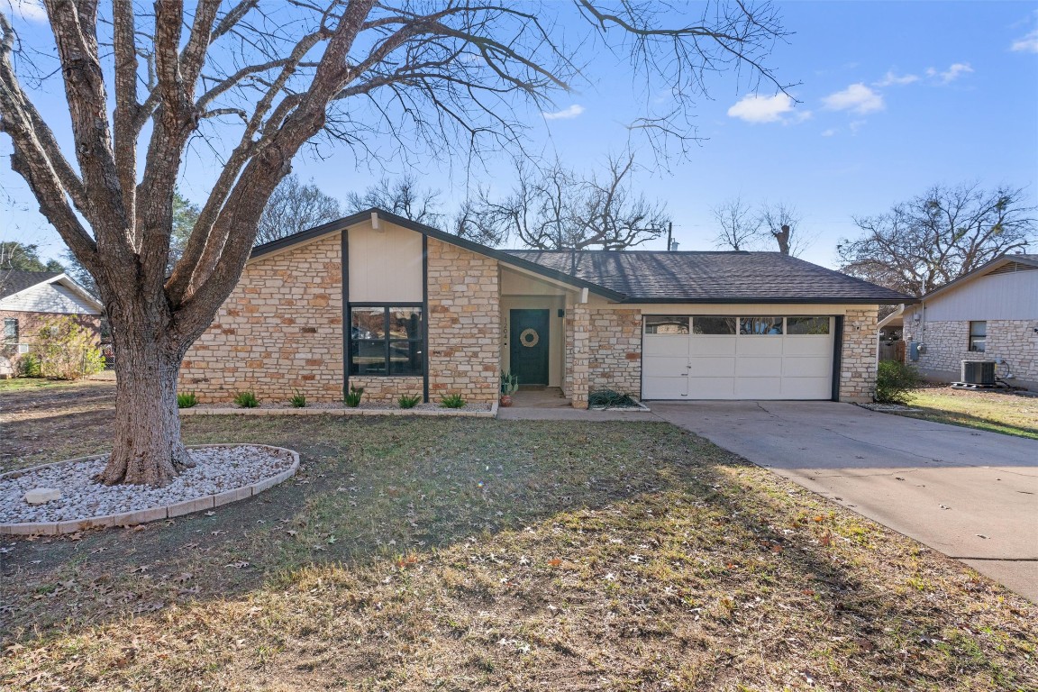 1204 Dunman Drive Georgetown, TX 78628 - Photo 1 of 40 a front view of a house with garden