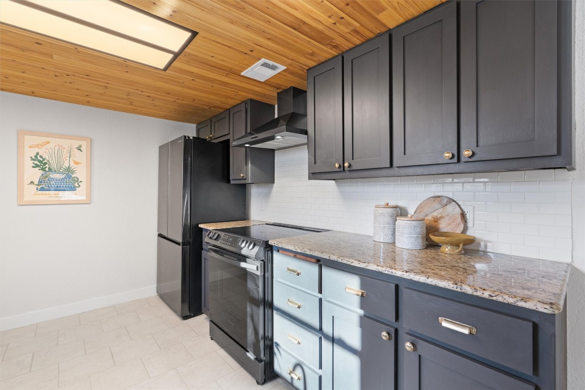 1204 Dunman Drive Georgetown, TX 78628 - Photo 15 of 40 a kitchen with stainless steel appliances granite countertop a refrigerator and a stove