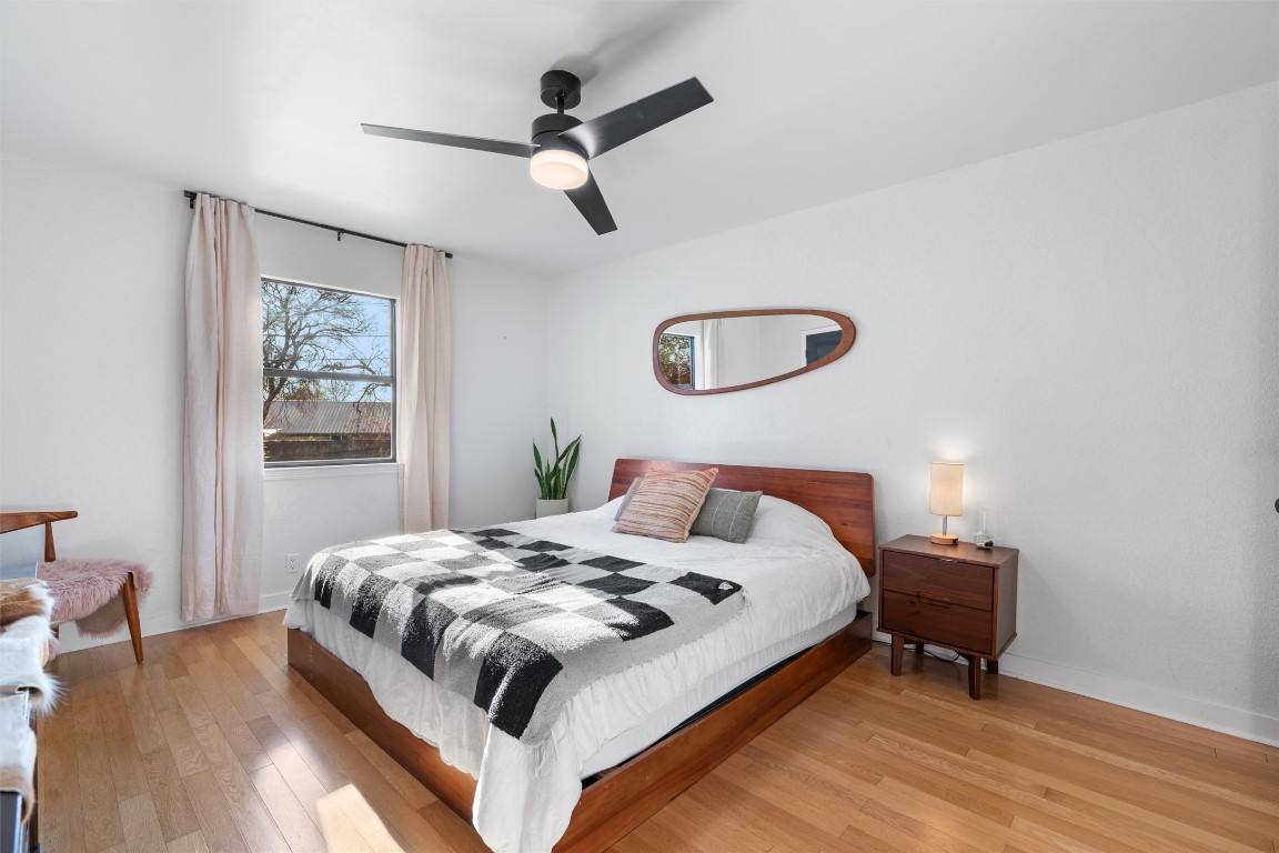 1204 Dunman Drive Georgetown, TX 78628 - Photo 17 of 40 a bedroom with a bed and a chandelier