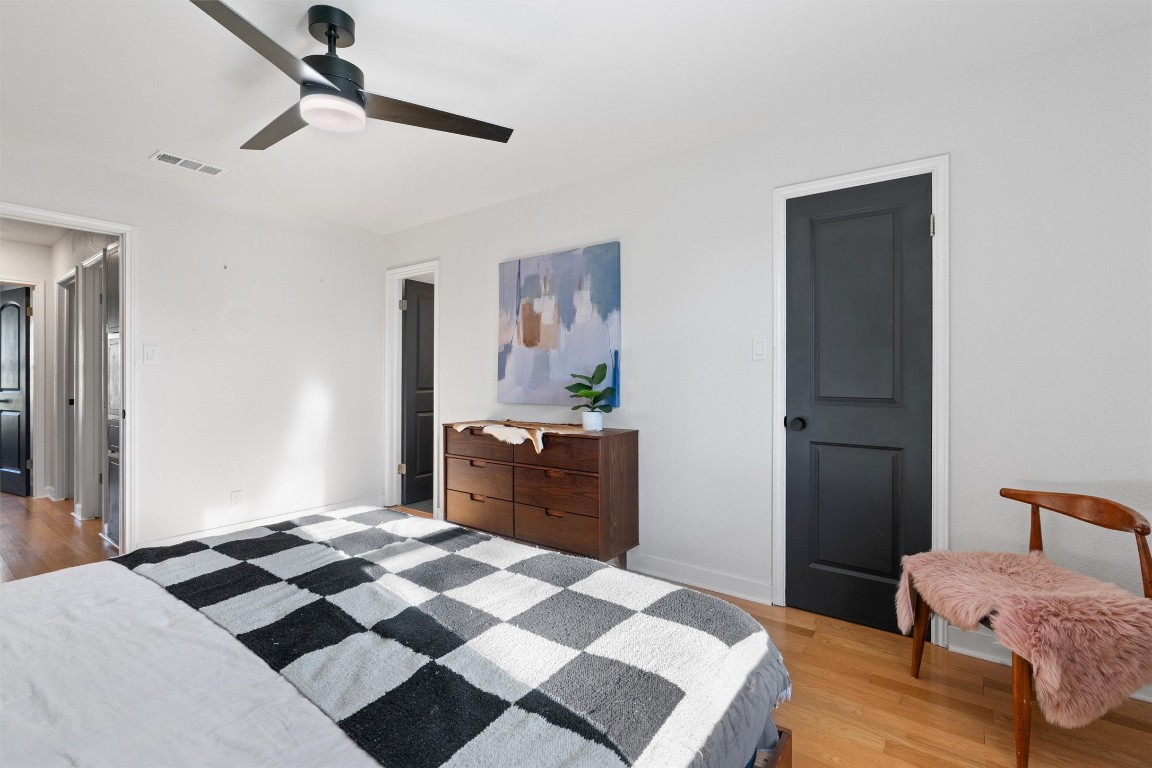 1204 Dunman Drive Georgetown, TX 78628 - Photo 18 of 40 a bedroom with a bed and wooden floor