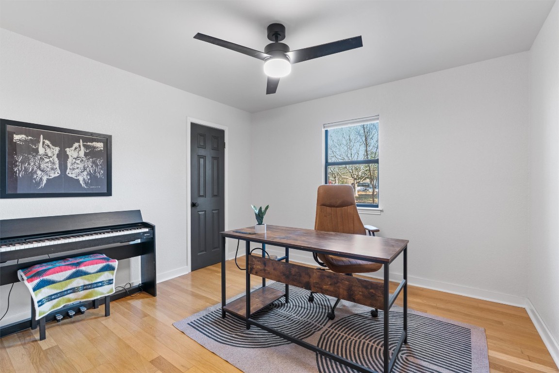 1204 Dunman Drive Georgetown, TX 78628 - Photo 22 of 40 a work room with furniture wooden floor and a flat screen tv