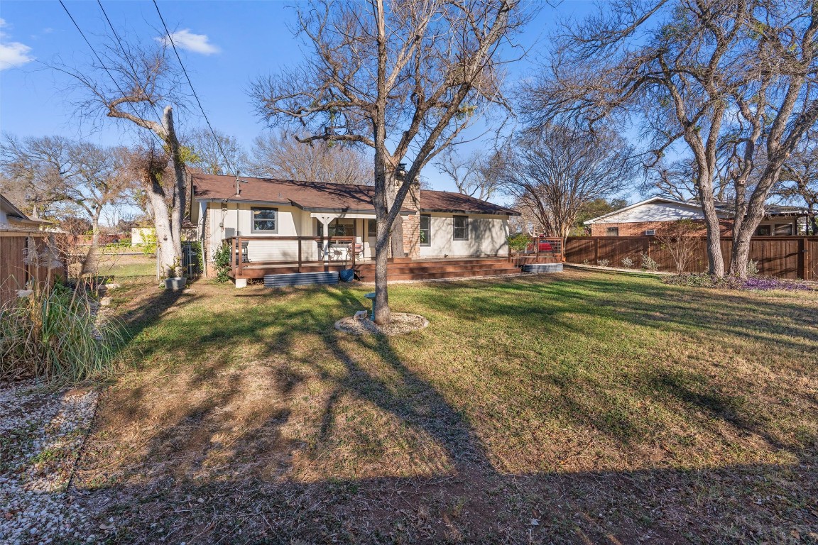 1204 Dunman Drive Georgetown, TX 78628 - Photo 31 of 40 a backyard of a house with large trees and outdoor seating