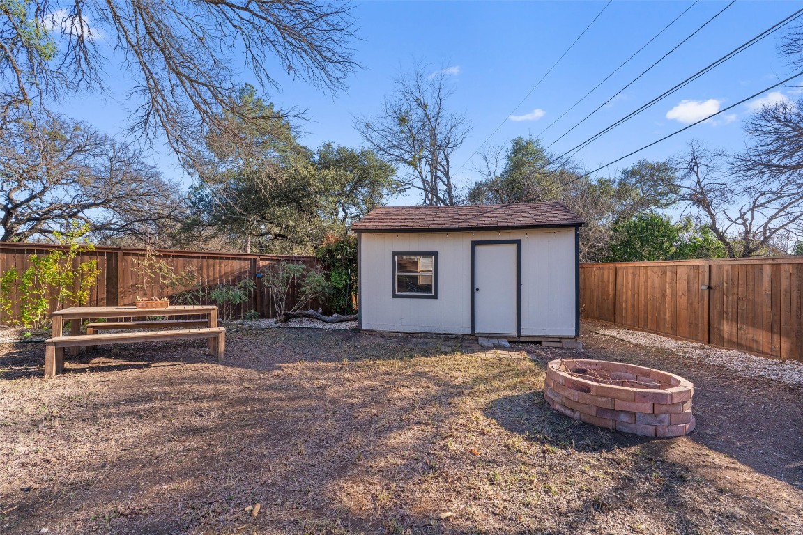 1204 Dunman Drive Georgetown, TX 78628 - Photo 34 of 40 a view of a backyard with wooden fence and a bench