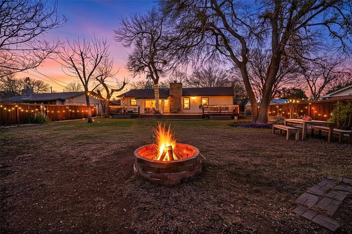 1204 Dunman Drive Georgetown, TX 78628 - Photo 4 of 40 a view of a backyard with a fire pit and a tree