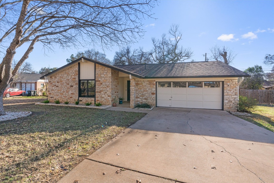 1204 Dunman Drive Georgetown, TX 78628 - Photo 9 of 40 a view of a house with a yard and garage