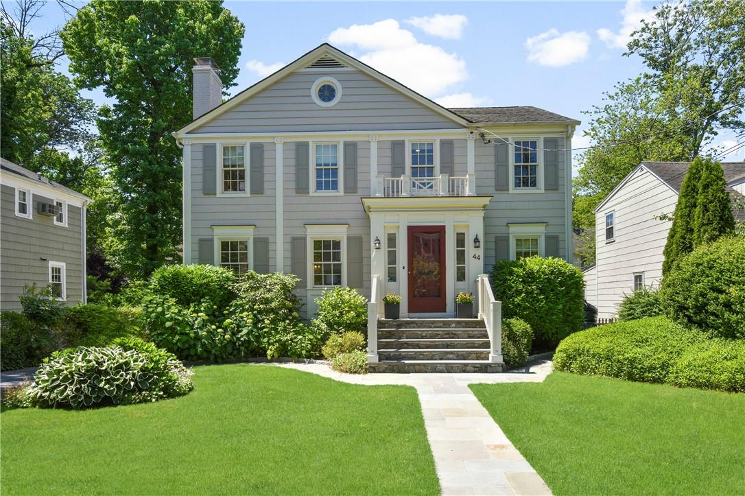 a front view of a house with a garden
