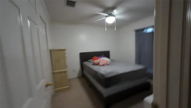 a bedroom with a bed and a flat tv screen on the dresser