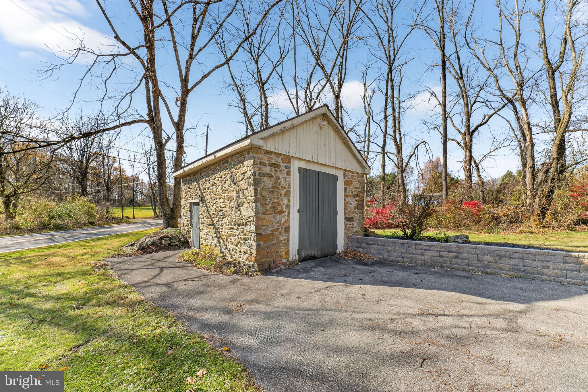 275 Sally Ann Furnace Road Mertztown, PA 19539 - Photo 30 of 33 Charming stone shed amidst serene landscape.