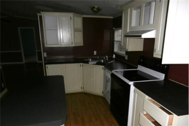 140 Sam Hollow Road Dickson, TN 37055 - Photo 7 of 11 a kitchen with a sink a stove and cabinets