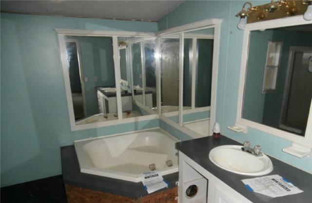140 Sam Hollow Road Dickson, TN 37055 - Photo 9 of 11 a bathroom with a tub sink and mirror