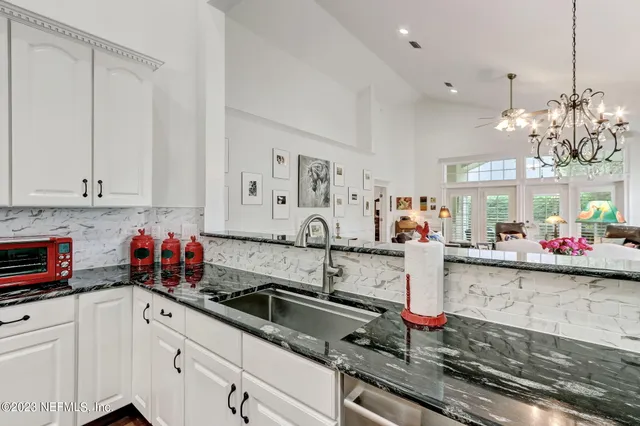 a view of a dining room with furniture and chandelier