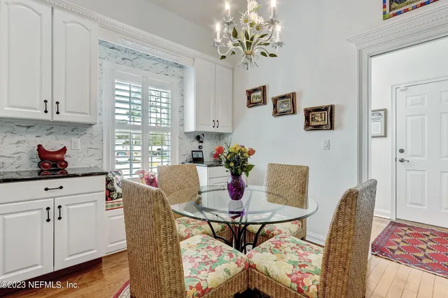 a view of a hallway with wooden floor and furniture