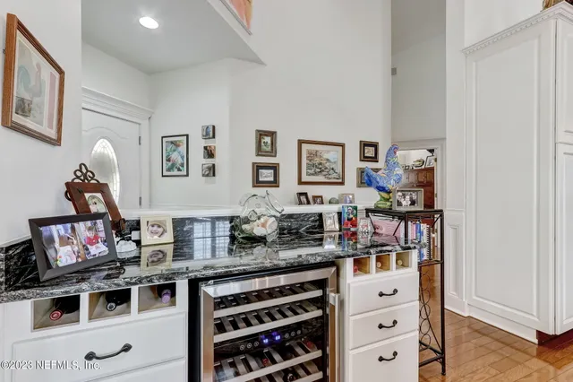 a view of a dining room with furniture and chandelier