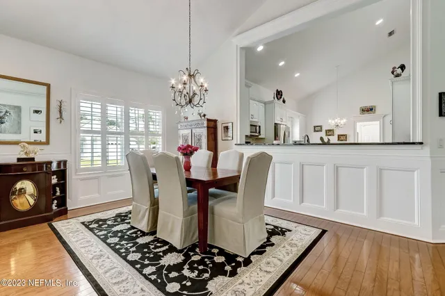 a living room with furniture a chandelier and a fireplace