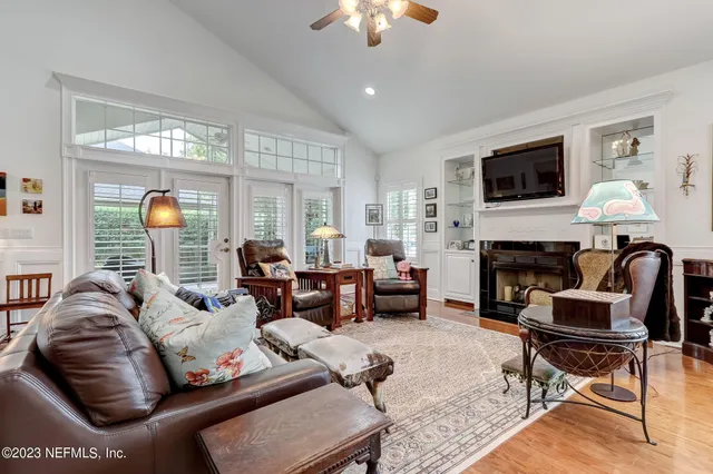 a bedroom with a bed and a large mirror on the dresser