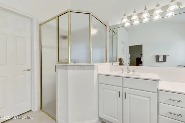 a bedroom with furniture and a large window