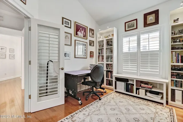 a kitchen with granite countertop a stove a sink and a white cabinets