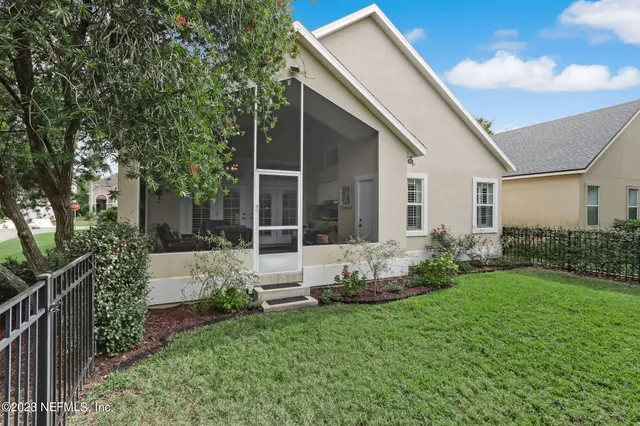 a view of a street sign under a large tree