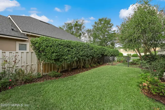 a view of swimming pool with table and chairs under an umbrella