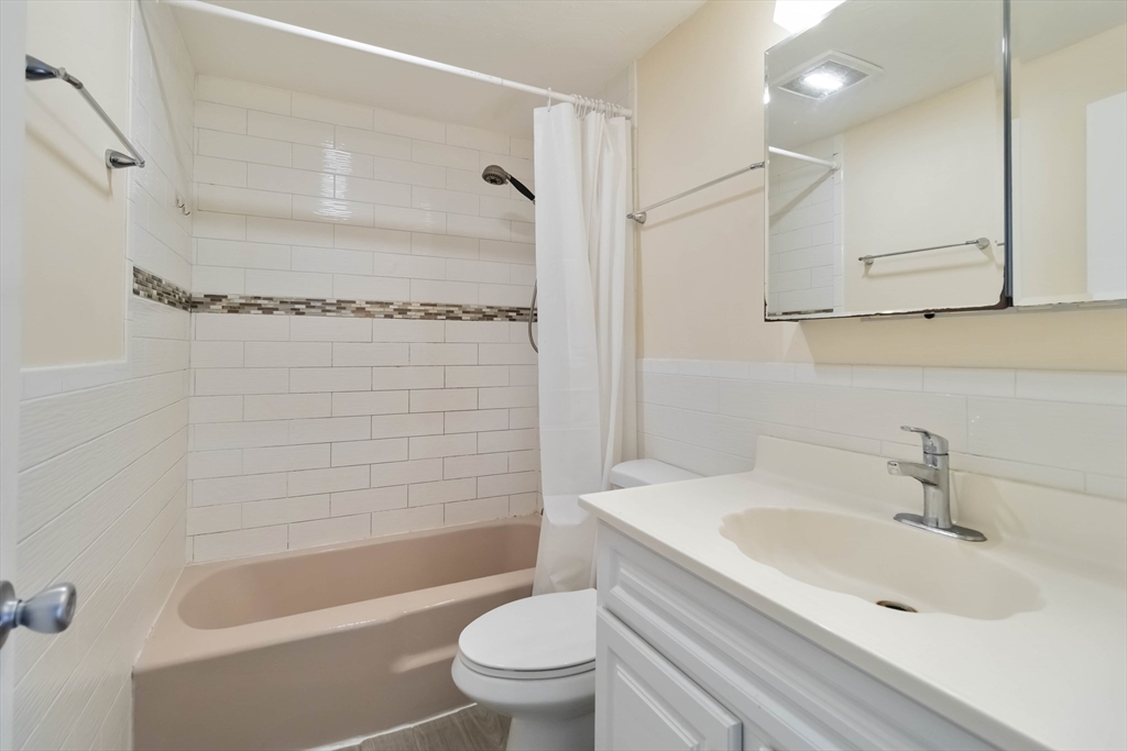 388 Great Road, Unit B14 Acton, MA 01720 - Photo 16 of 24 a bathroom with a sink a toilet and a bathtub