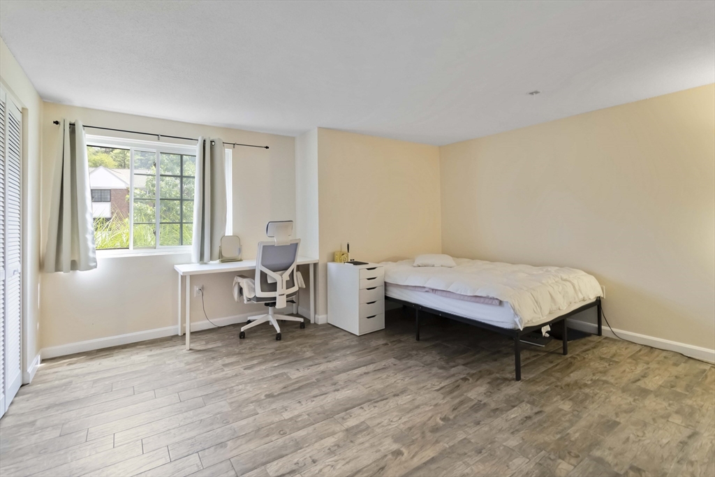 388 Great Road, Unit B14 Acton, MA 01720 - Photo 19 of 24 a living room with a bed furniture and a window