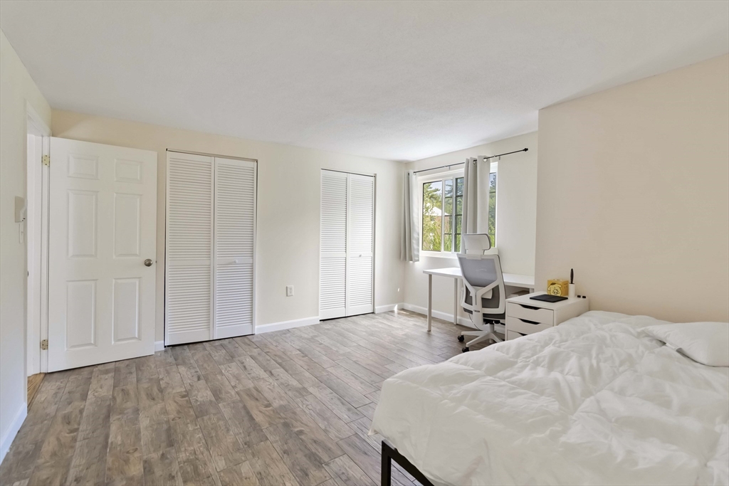 388 Great Road, Unit B14 Acton, MA 01720 - Photo 21 of 24 a bedroom with a bed and a window