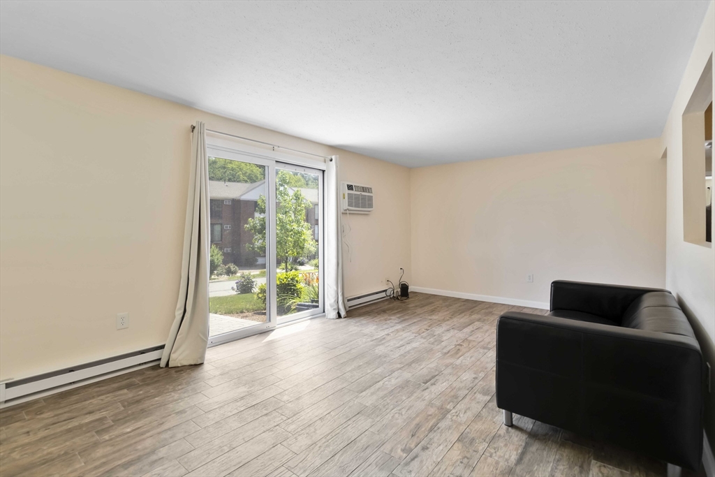 388 Great Road, Unit B14 Acton, MA 01720 - Photo 5 of 24 a living room with furniture and a window