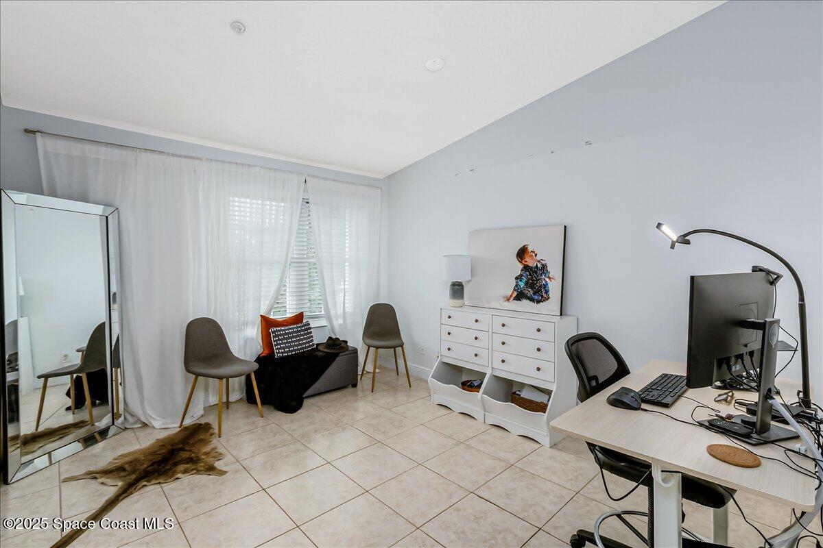 7667 North Wickham Road, Unit 118 Melbourne, FL 32940 - Photo 12 of 23 a living room with furniture and a flat screen tv