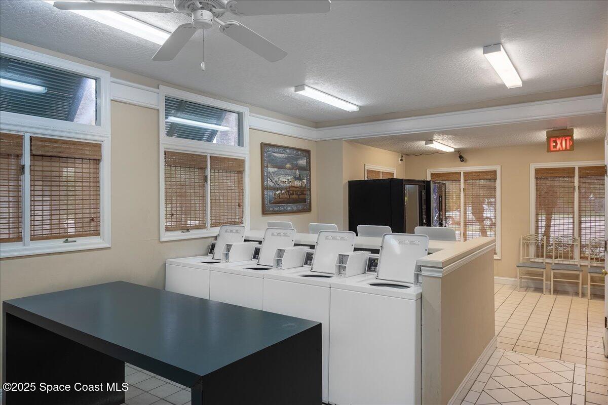 7667 North Wickham Road, Unit 118 Melbourne, FL 32940 - Photo 19 of 23 a kitchen with a stove a sink and a refrigerator