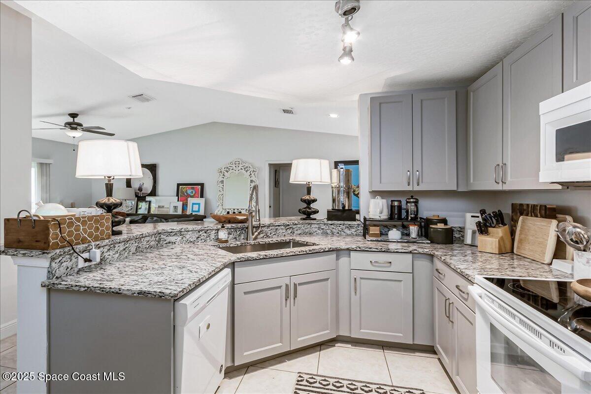 7667 North Wickham Road, Unit 118 Melbourne, FL 32940 - Photo 23 of 23 a kitchen with a sink stove and cabinets