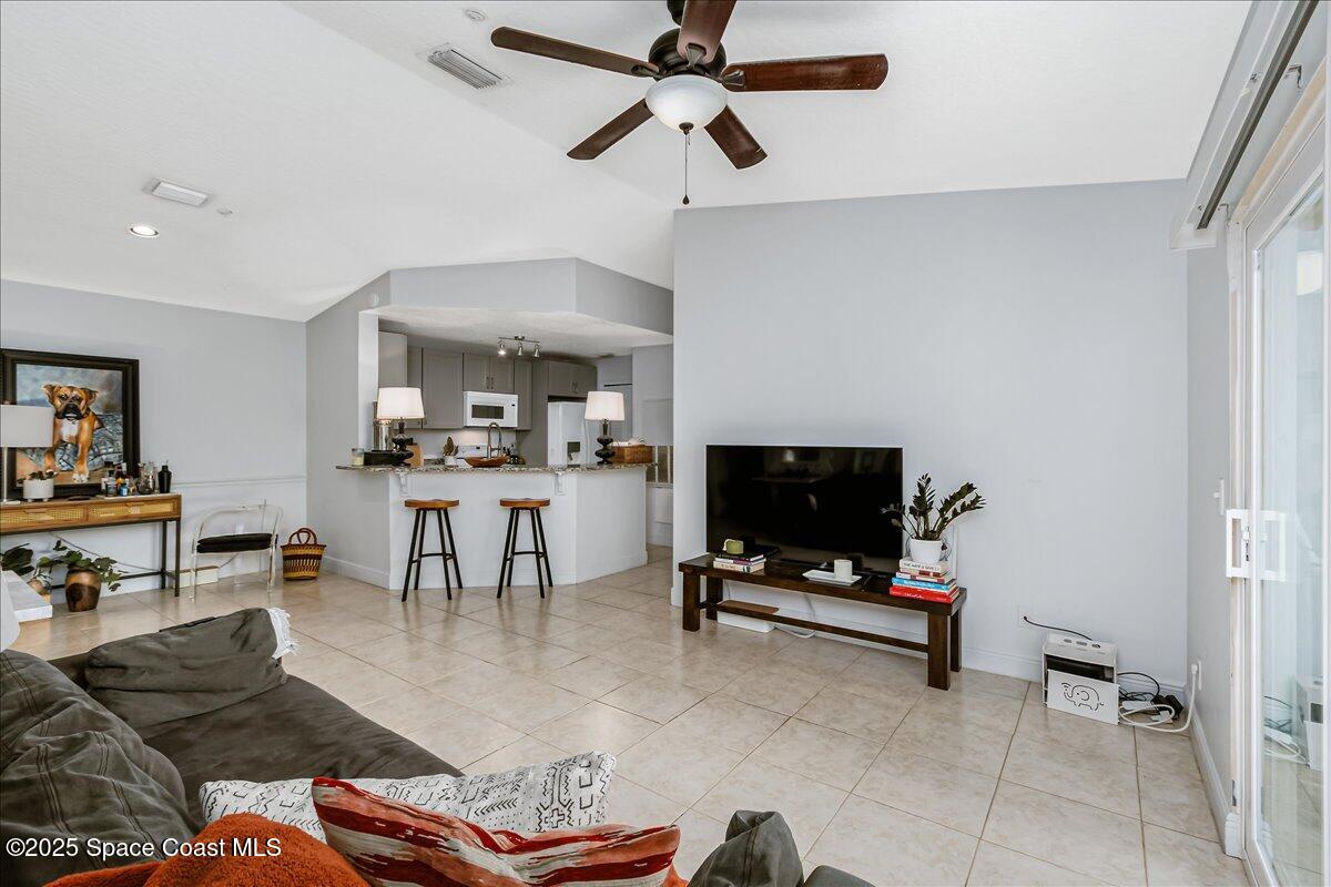 7667 North Wickham Road, Unit 118 Melbourne, FL 32940 - Photo 7 of 23 a living room with furniture and a flat screen tv