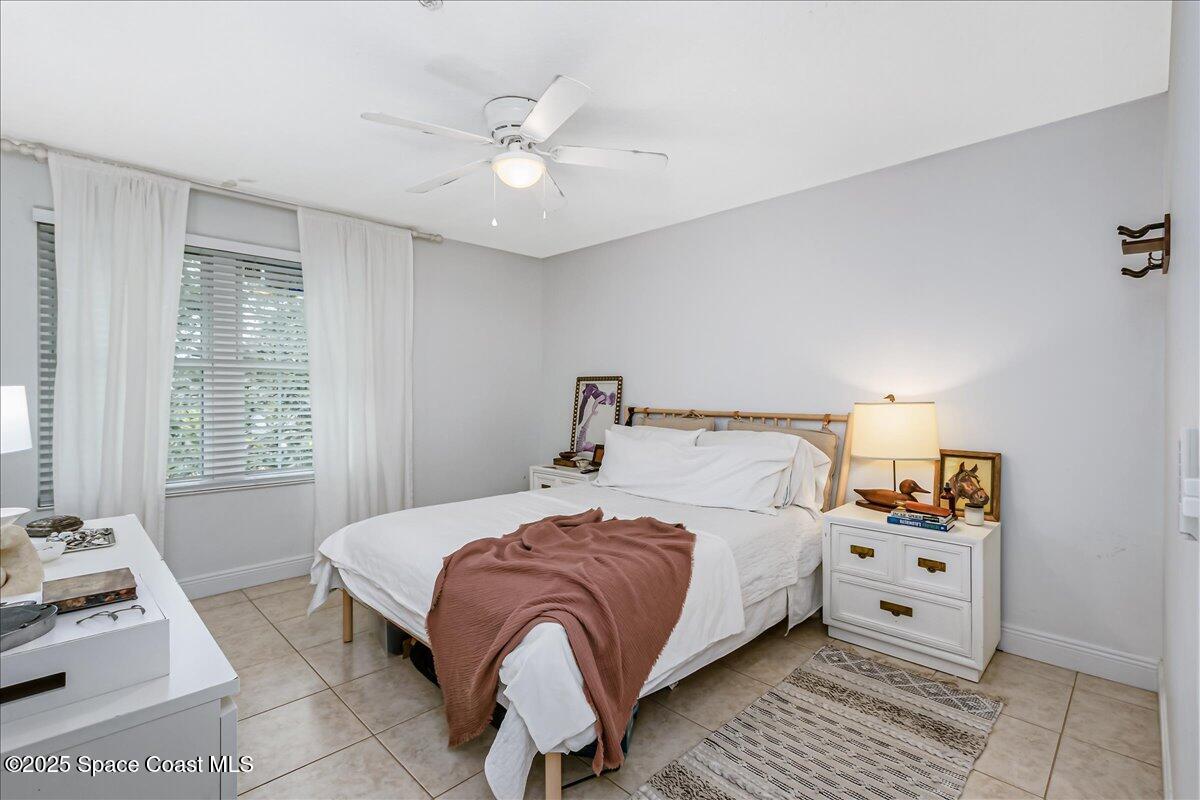 7667 North Wickham Road, Unit 118 Melbourne, FL 32940 - Photo 9 of 23 a bedroom with a bed and a window