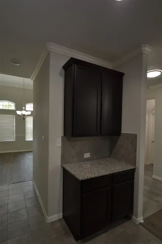 a kitchen with granite countertop a sink and cabinets