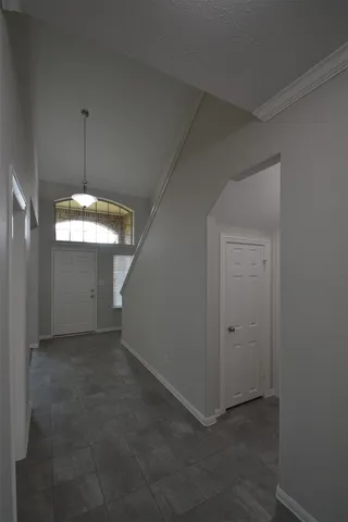 an empty room with windows and entrance