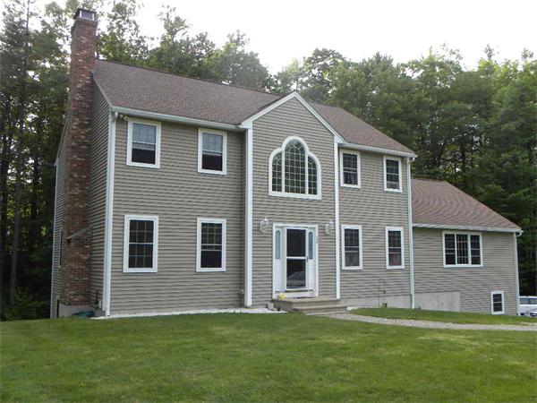 12 Lincoln Point Road Charlton, MA 01507 - Photo 1 of 30 a front view of a house with a garden