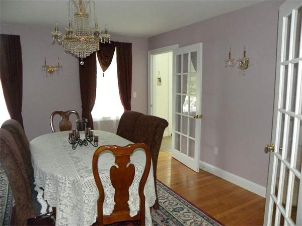 12 Lincoln Point Road Charlton, MA 01507 - Photo 17 of 30 a dining room with furniture a chandelier and wooden floor