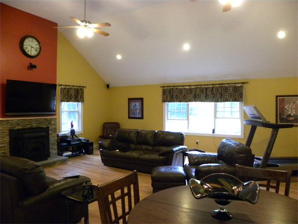 12 Lincoln Point Road Charlton, MA 01507 - Photo 27 of 30 a living room with furniture flat screen tv and a fireplace