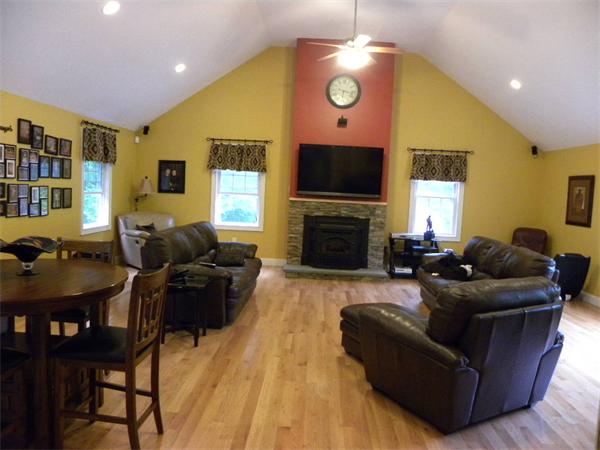 12 Lincoln Point Road Charlton, MA 01507 - Photo 4 of 30 a living room with furniture a flat screen tv and a fireplace