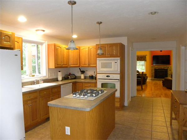 12 Lincoln Point Road Charlton, MA 01507 - Photo 8 of 30 a kitchen with a appliances a center island cabinets and wooden floor