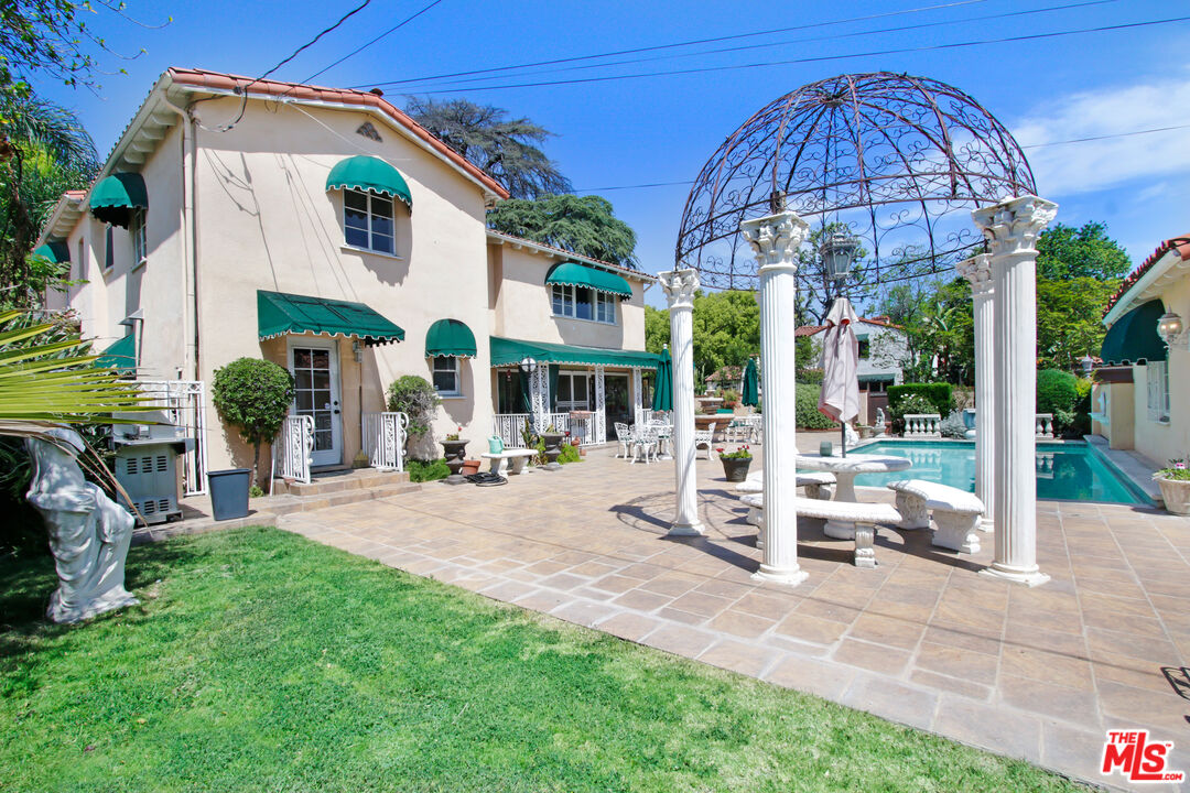 303 Armsley Square Ontario, CA 91762 - Photo 12 of 13 a view of a house with backyard sitting area and porch