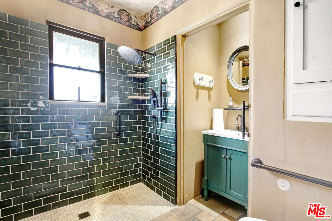 303 Armsley Square Ontario, CA 91762 - Photo 5 of 13 a bathroom with a sink a mirror and shower