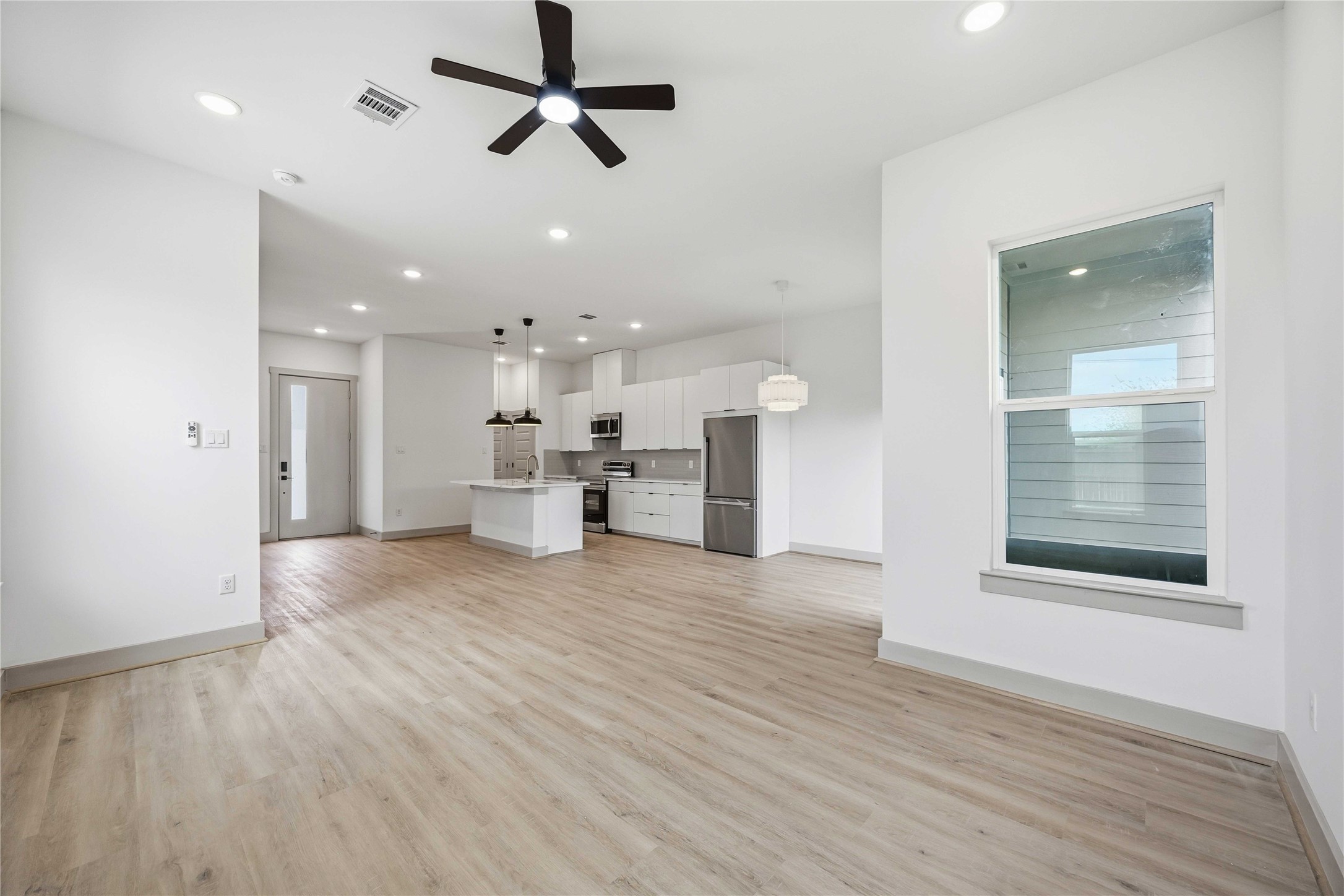7555 Calhoun Road, Unit A/B Houston, TX 77033 - Photo 13 of 27 a view of empty room with wooden floor and windows