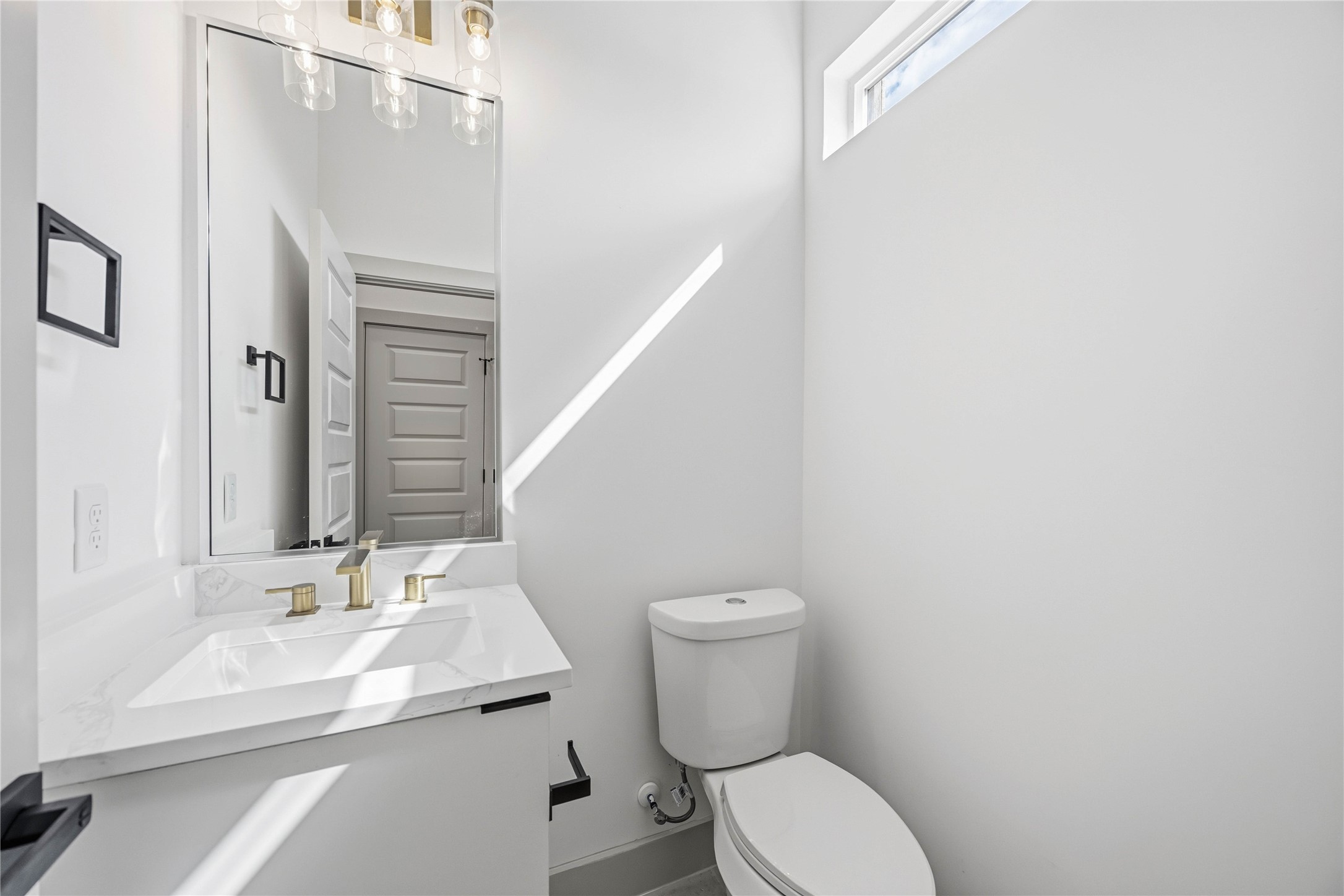 7555 Calhoun Road, Unit A/B Houston, TX 77033 - Photo 14 of 27 a white toilet sitting next to a bathroom sink